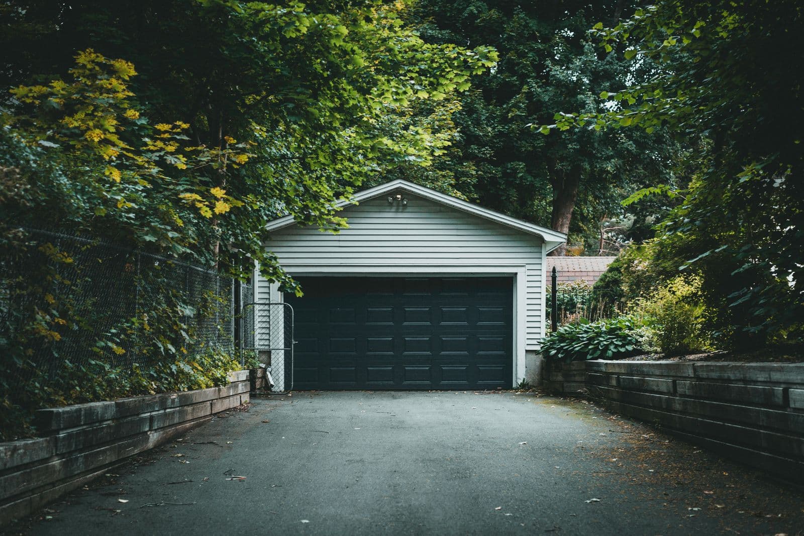Freshly paved asphalt driveway at a suburban home